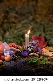 Сandle, Fruits, Berries, Autumn Leaves, Crystal Gemstones In Forest. Wiccan Altar For Mabon Sabbat. Autumn Equinox Holiday. Witchcraft, Esoteric Spiritual Ritual