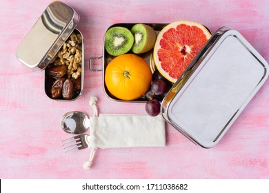 Fruits In A Big Stainless Steel Food Container. Dry Dates And Nuts In Small Plastic Free Lunch Box. Metal Spoon And Fork Near It.  Zero Waste, Eco Friendly. 