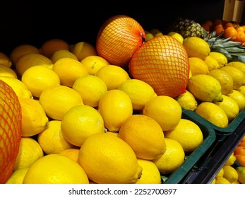 Fruits counter shelf in the city supermarket with ripe lemons. Retail market backgrounds - Shutterstock ID 2252700897
