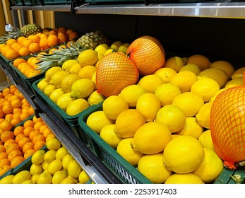 Fruits counter shelf in the city supermarket with ripe lemons and oranges. Shop and bazaar backgrounds - Shutterstock ID 2253917403