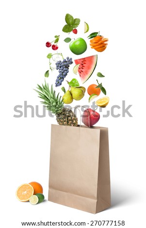 Fruits falling into bag isolated on white background. Healthy eating concept