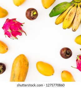 Fruits frame of banana, papaya, mango with mangosteen and dragon fruits on white background. Flat lay. Top view. Tropical fruit concept