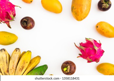 Fruits frame of banana, papaya, mango with mangosteen and dragon fruits on white background. Flat lay. Top view. Tropical fruit
