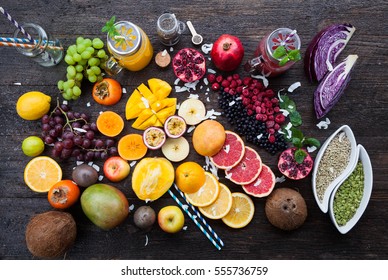 Fruits And Frozen Berries On Dark Rustic Wooden Table. Purple And Yellow Smoothie Bowl Formula. Clean Eating Concept. Various Green And Red Veggies, Fruit And Superfoods Ready To Prepare Smoothie Bowl