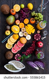 Fruits And Frozen Berries On Dark Rustic Wooden Table. Purple And Yellow Smoothie Bowl Formula. Clean Eating Concept. Various Green And Red Veggies, Fruit And Superfoods Ready To Prepare Smoothie Bowl