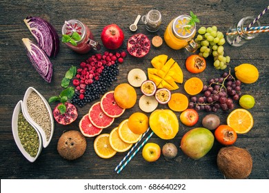 Fruits And Frozen Berries On Dark Rustic Wooden Table. Purple And Yellow Smoothie Bowl Formula.Clean Eating Concept. Various Green And Red Veggies, Fruit And Superfoods Ready To Prepare Smoothie Bowl
