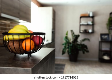 Fruits In Fruit Bowl On Bar Counter In Stylish Loft Kitchen. Blurred Background