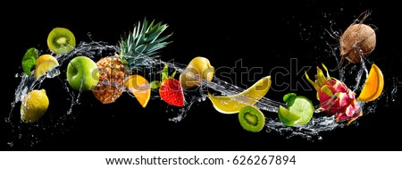 Fruits on black background with water splash