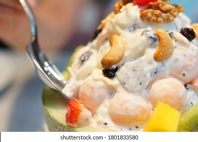 Fruits Salad Mix With Cantaloupe Strawberry Mango Kiwi Cashew Nuts Cherry And Dragon Fruit In Cantaloupe Shell Bowl With Spoon For Diet Juicy Dessert And Vitamins Food Nutrition On Warm White