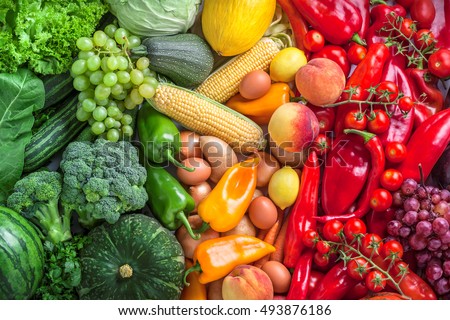 Fruits and vegetables fresh large rainbow overhead assortment colorful background green, yellow to red in studio