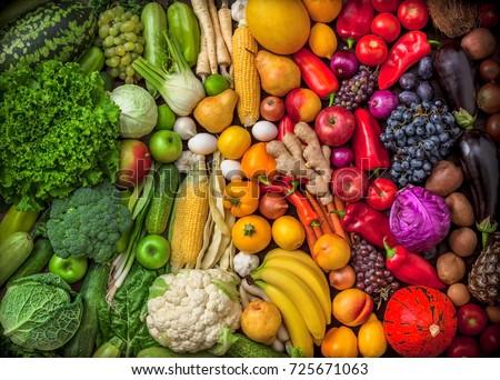 Fruits and vegetables large overhead assortment on colorful background in studio green, white, yellow to red