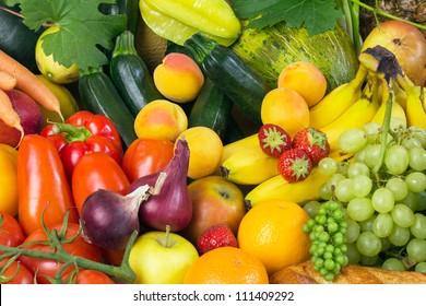 Fruits and vegetables like tomatoes, zucchini, melons, bananas and grapes arranged in a group, natural still life for healthy food - Powered by Shutterstock