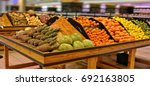 Fruits and vegetables on display in a supermarket. Food store. Pineapple, melon, grapefruit, tangerine, orange, lemon. Organic food. Beautiful image. 