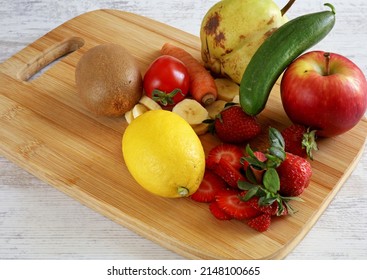 Fruits And Vegetables On Wooden Chopper Table