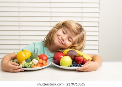 Fruits and vegetables. Schoolkid eating breakfast before school. Portrait of child sit at desk at home kitchen have delicious tasty nutritious breakfast.