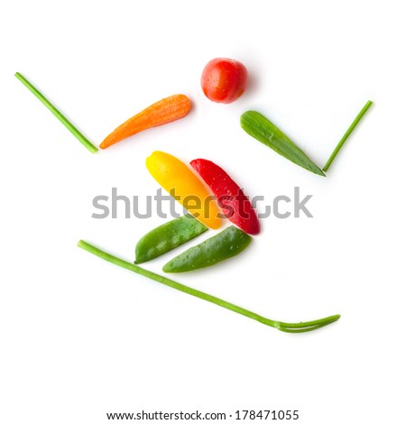 Fruits and vegetables in the shape of a slalom skier sliding downhill.
