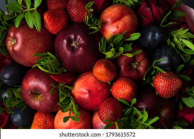 fruity bouquet of red apples with plums, red pepper, strawberry and pistachio branches. On a wooden table and gray background. - Shutterstock ID 1793615572