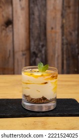 Fruity Desserts. Closeup View Of A Glass With Passion Fruit Mousse, With Oatmeal And Nuts. 