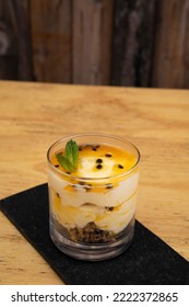 Fruity Desserts. Closeup View Of A Glass With Passion Fruit Mousse, With Oatmeal And Nuts.