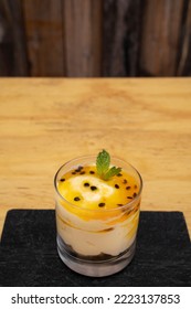 Fruity Desserts. Closeup View Of A Glass With Passion Fruit Mousse, With Oatmeal And Nuts.