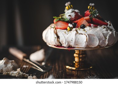 Fruity pavlova cake on a gold stand - Shutterstock ID 1747988150