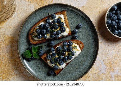 Fruity topped bread with blueberries on Greek yogurt. Healthy toast (tartine).  - Shutterstock ID 2182348783