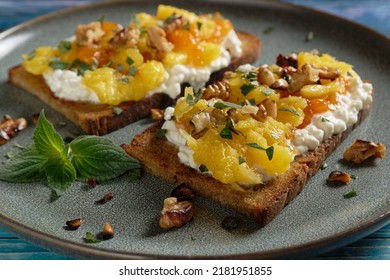 Fruity topped bread with caramelized mango pieces on cottage cheese. Healthy toast (tartine).  - Shutterstock ID 2181951855