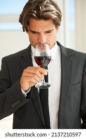 Fruity Yet Playful. A Handsome Wine Connoisseur Enjoying A Glass Of Red Wine.