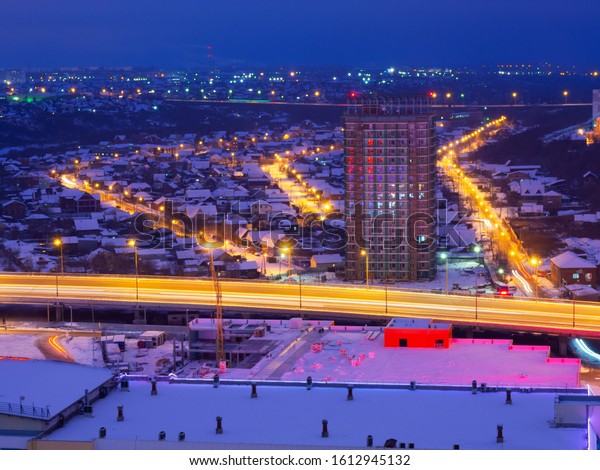Frunzensky bridge, a new building and\
illuminated streets in the private sector of the city of Omsk:\
Podgornaya, Kuzbass and\
Deputatskaya