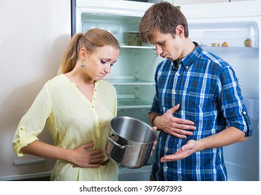 Frustraited Starving Female And American Man Near Fridge Without Any Food 