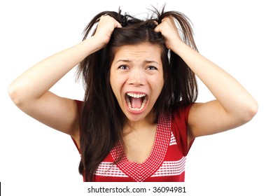 Frustrated and angry mad woman going crazy hands pulling her hair. Isolated on white background