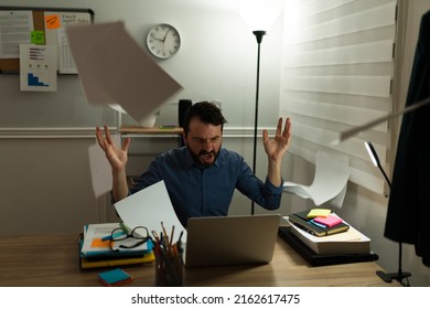 Frustrated Angry Man With A Lot Of Work Feeling Overwhelmed And Tired While Throwing The Work Papers From His Desk