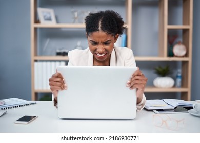 Frustrated, Angry And Stressed Young Business Woman On A Laptop In A Modern Office. Female Showing Anger With Technology At The Workplace. Lady Employee Grabbing Computer Due To Slow Connection