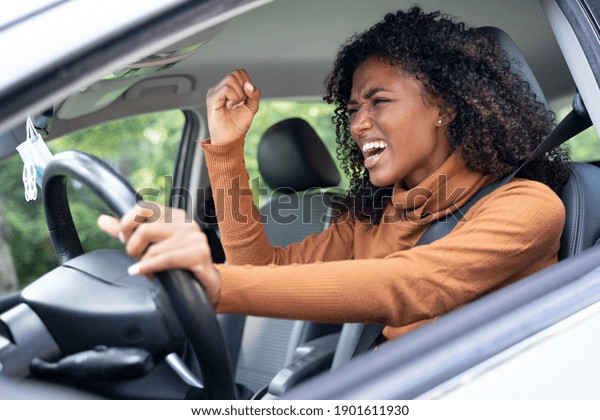 Frustrated angry woman\
stuck in traffic jam