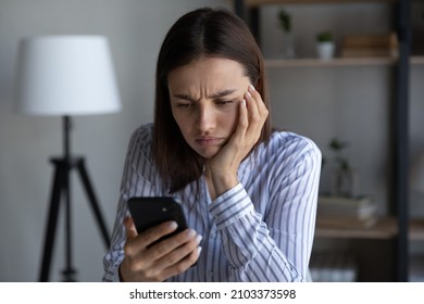 Frustrated annoyed smartphone user upset about problems with mobile phone, online app, virtual services, errors, mistakes, holding cellphone, looking at screen with frowning, angry, upset face