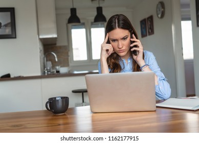 Frustrated Annoyed Woman Confused By Computer Problem And Talking On Phone