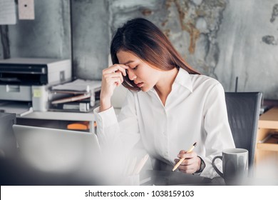 Frustrated Asian businesswoman cover her face with two hand and feel upset from work in front of laptop computer on desk at office,Stress office lifestyle concept