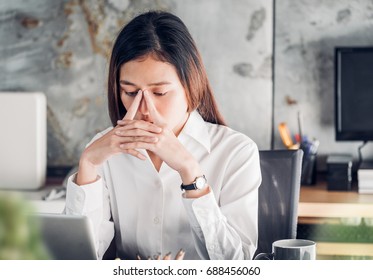 Frustrated Asian Businesswoman Cover Her Face With Two Hand And Feel Upset From Work In Front Of Laptop Computer On Desk At Office,Stress Office Lifestyle Concept