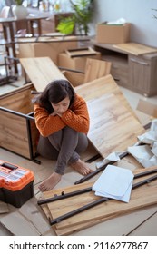 Frustrated Asian Woman While Assembling New Furniture