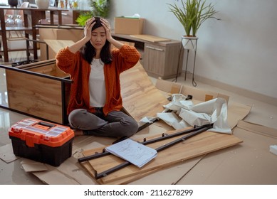 Frustrated Asian Woman While Assembling New Furniture