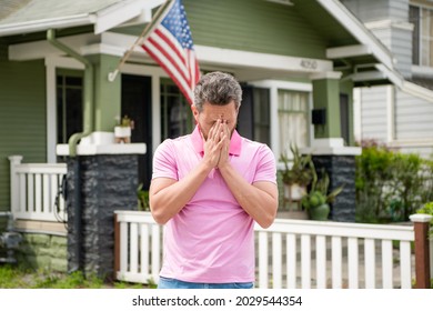 frustrated bearded man realtor selling or renting house with american flag, insurance