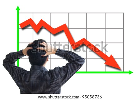 Frustrated business man looking at the falling graph of a stock market struck in financial crisis