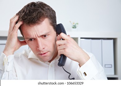 Frustrated Business Man Waiting On The Phone In A Hotline Queue