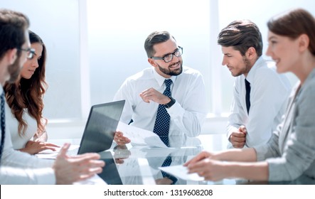 Frustrated Business People Sitting At The Table In Office