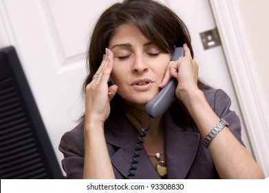 Frustrated Business Woman With Headache Working In Home Office