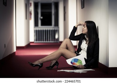 Frustrated Businesswoman Sitting On The Corridor Of The Hotel.