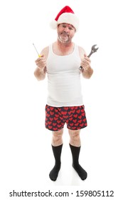 Frustrated Dad In A Santa Hat Holding His Tools.  He Looks Scruffy, Like He's Been Up All Night Assembling Christmas Presents.  Full Body Isolated On White.