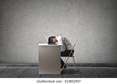 Frustrated Employee Sitting At His Desk