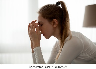 Frustrated female manage emotions feeling broken after hearing bad news, upset girl sit with eyes closed cope with anxiety or depression, hurt heartbroken woman stressed after breaking up or split