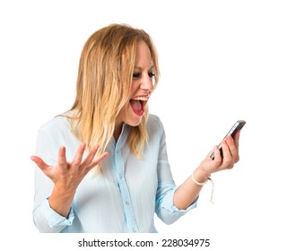 Frustrated girl talking to mobile over white background - Shutterstock ID 228034975